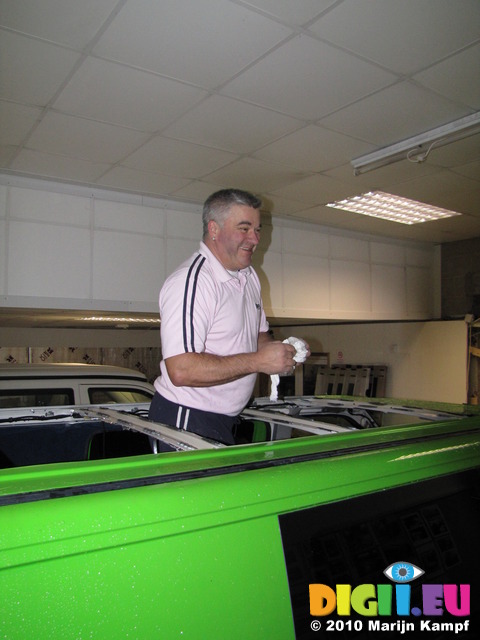 SX12322 Simon standing in hole in roof of campervan